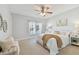 Spacious bedroom with ocean view, ceiling fan, and plush bedding at 4950 Gulf Blvd # 206, St Pete Beach, FL 33706