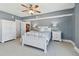 Bright bedroom with white bed and built-in storage at 4950 Gulf Blvd # 206, St Pete Beach, FL 33706