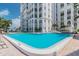 Inviting community pool with surrounding lounge chairs at 4950 Gulf Blvd # 206, St Pete Beach, FL 33706