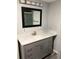 Modern bathroom with gray vanity, quartz countertop, and updated fixtures at 519 Greenway Dr, Plant City, FL 33566