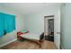 Small bedroom with teal curtains and a hospital bed at 519 Greenway Dr, Plant City, FL 33566