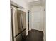 Hallway with stainless steel refrigerator and access to other rooms at 519 Greenway Dr, Plant City, FL 33566