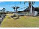 Landscaped backyard with a spacious patio and white fence at 5205 Covesound Way, Apollo Beach, FL 33572