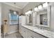 Elegant bathroom with double vanity and granite countertops at 5205 Covesound Way, Apollo Beach, FL 33572