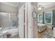 Bathroom with tub and shower, and adjacent bedroom view at 5205 Covesound Way, Apollo Beach, FL 33572