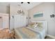 Bright bedroom with a queen-size bed and wood flooring at 5205 Covesound Way, Apollo Beach, FL 33572