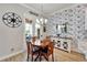 Bright breakfast nook with table and chairs, featuring a tropical-themed wall at 5205 Covesound Way, Apollo Beach, FL 33572