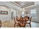 Elegant dining room with a round table, chandelier, and hardwood floors at 5205 Covesound Way, Apollo Beach, FL 33572