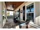 Relaxing front porch with seating area and wood ceiling at 5205 Covesound Way, Apollo Beach, FL 33572