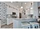 Kitchen with white cabinets, granite counters, and breakfast bar at 5205 Covesound Way, Apollo Beach, FL 33572