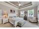 Main bedroom with king bed, tray ceiling, and calming decor at 5205 Covesound Way, Apollo Beach, FL 33572