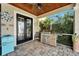 Outdoor kitchen with stainless steel appliances and a turquoise fridge at 5205 Covesound Way, Apollo Beach, FL 33572