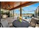 Covered patio with outdoor dining set and built-in grill at 5205 Covesound Way, Apollo Beach, FL 33572