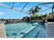 Inviting swimming pool with screened enclosure and lake view at 5205 Covesound Way, Apollo Beach, FL 33572