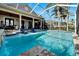 Inviting pool and patio with water feature and chairs at 5205 Covesound Way, Apollo Beach, FL 33572