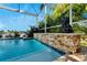 Screened pool area with waterfall and stone accents at 5205 Covesound Way, Apollo Beach, FL 33572