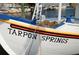 Close-up of a boat with 'Tarpon Springs' on its side at 1408 Riverside Dr, Tarpon Springs, FL 34689