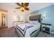 Comfortable main bedroom with a soft color palette and a decorative ceiling fan at 1575 Wicklow Dr, Palm Harbor, FL 34684