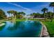 Community entrance featuring a pond with a fountain and lush landscaping at 1575 Wicklow Dr, Palm Harbor, FL 34684