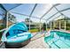 Comfortable outdoor lounge area with a daybed next to the pool inside the screened enclosure at 1575 Wicklow Dr, Palm Harbor, FL 34684