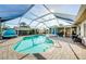 Screened pool featuring a sun shelf, brick pavers, and plenty of seating at 1575 Wicklow Dr, Palm Harbor, FL 34684