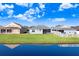 Home's rear elevation, showcasing a pond view at 4214 Duck Creek Way, Ellenton, FL 34222