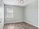 Light-grey bedroom featuring wood-look floors and ceiling fan at 4214 Duck Creek Way, Ellenton, FL 34222