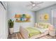 Bedroom with a light-green bed and floating shelves at 4214 Duck Creek Way, Ellenton, FL 34222