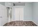 Bedroom with grey walls, wood floors and double doors to closet at 4214 Duck Creek Way, Ellenton, FL 34222