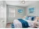 Bedroom with a queen bed and nautical-themed decor at 4214 Duck Creek Way, Ellenton, FL 34222