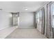 Bright living room with tile and carpet flooring, featuring a view into the kitchen at 4214 Duck Creek Way, Ellenton, FL 34222