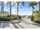 Beach access path with signage and palm trees at 322 Windrush Blvd # 4, Indian Rocks Beach, FL 33785