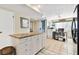 Kitchen with granite island and white cabinetry at 322 Windrush Blvd # 4, Indian Rocks Beach, FL 33785
