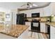Modern kitchen featuring granite countertops and stainless steel appliances at 322 Windrush Blvd # 4, Indian Rocks Beach, FL 33785