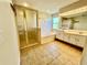 Bathroom with double vanity, bathtub, and shower at 3619 Springville Dr, Valrico, FL 33596