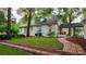 Brick home with a side yard pathway and mature trees at 37439 Meridian Ave, Dade City, FL 33525