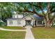 Charming brick home with a welcoming front porch and lush lawn at 37439 Meridian Ave, Dade City, FL 33525