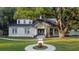 Renovated brick home featuring a large oak tree and landscaped yard at 37439 Meridian Ave, Dade City, FL 33525