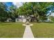 Renovated brick home with a large oak tree and landscaped yard at 37439 Meridian Ave, Dade City, FL 33525