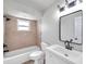 Renovated bathroom with neutral tile, a bathtub, and updated vanity at 9126 109Th Ter, Seminole, FL 33777