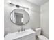 Updated bathroom with a white vanity, oval mirror, and modern fixtures at 9126 109Th Ter, Seminole, FL 33777