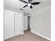 Light and airy bedroom with white closet doors and wood-look flooring at 9126 109Th Ter, Seminole, FL 33777
