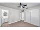 Bright bedroom with wood-look flooring, ceiling fan, and ample closet space at 9126 109Th Ter, Seminole, FL 33777