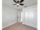 Bedroom with ceiling fan, double door closet and bathroom access at 9126 109Th Ter, Seminole, FL 33777