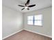 Simple bedroom with ceiling fan and large window with blinds at 9126 109Th Ter, Seminole, FL 33777