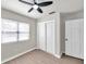 Bright bedroom with ceiling fan, large closet, and wood-look flooring at 9126 109Th Ter, Seminole, FL 33777