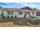Newly renovated home with a charming front porch and well-manicured landscaping at 9126 109Th Ter, Seminole, FL 33777