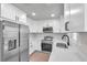Newly renovated kitchen, featuring stainless steel appliances and white shaker cabinets at 9126 109Th Ter, Seminole, FL 33777