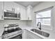Updated kitchen with stainless steel appliances and a farmhouse sink at 9126 109Th Ter, Seminole, FL 33777