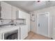 Laundry room with washer, dryer, cabinets and exterior access at 9126 109Th Ter, Seminole, FL 33777